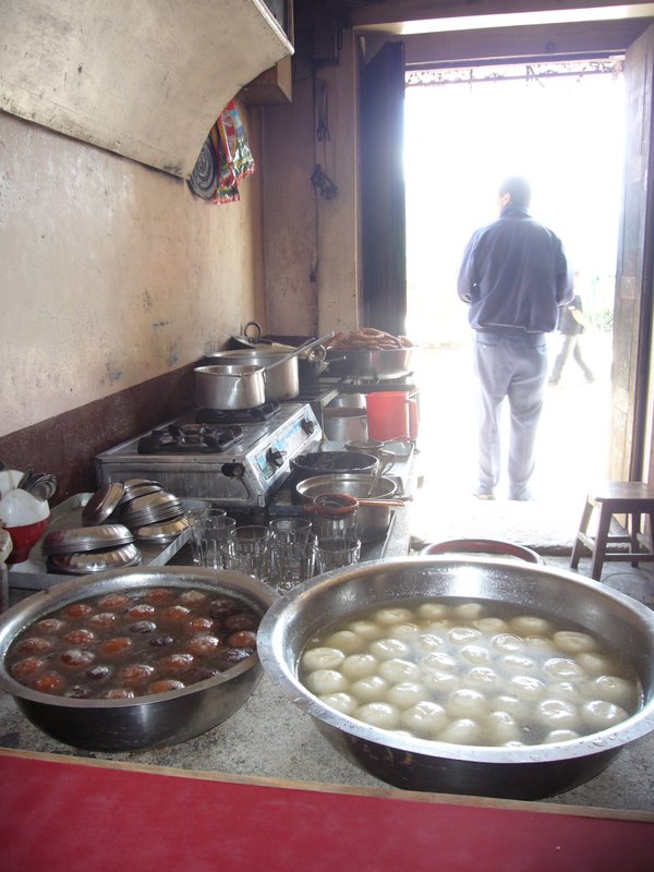 Back in Dhulikel for a quick place of veg momo surrounded by tubs full of sweets.